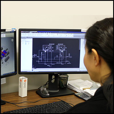 Woman looking at schematics on computer